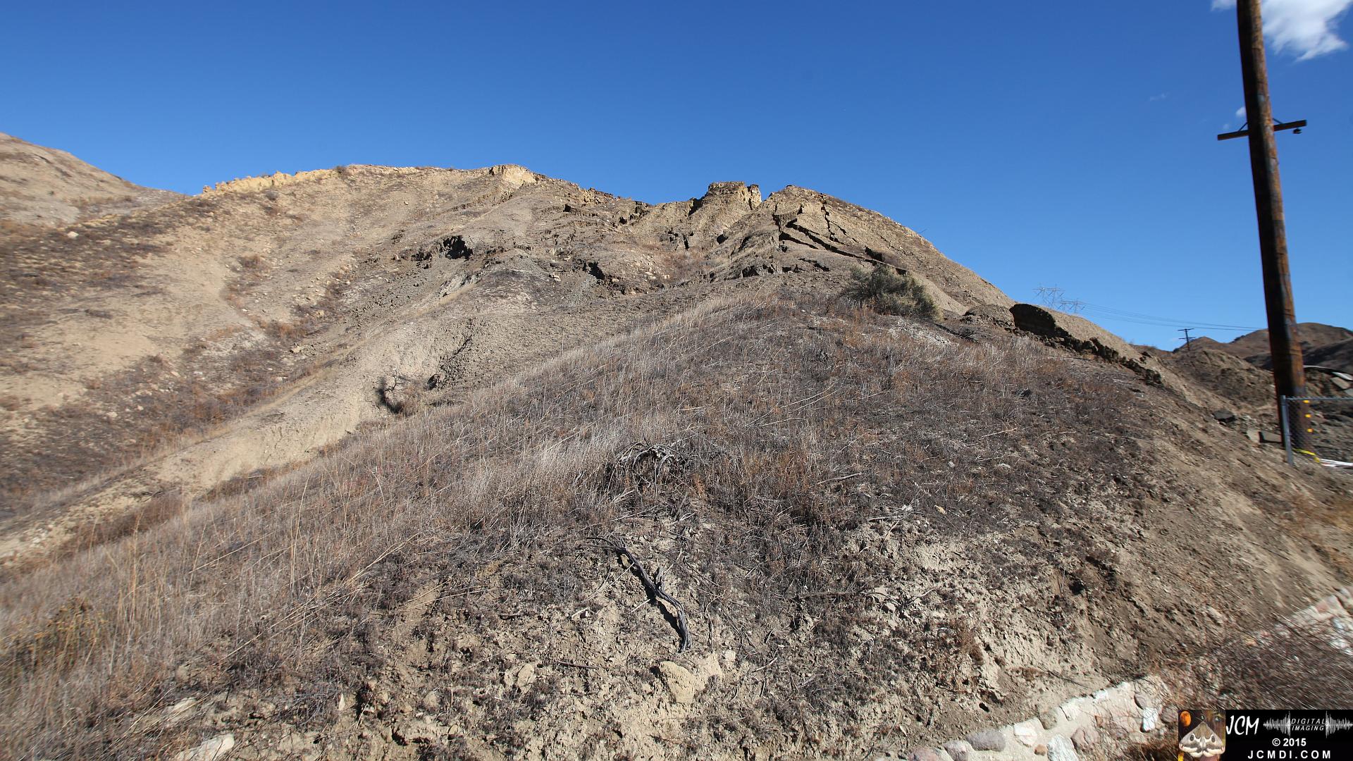 Landslide, buckled pavement, and terrain at Vasquez Canyon Road in Santa Clarita, CA filmed 11-25-2015